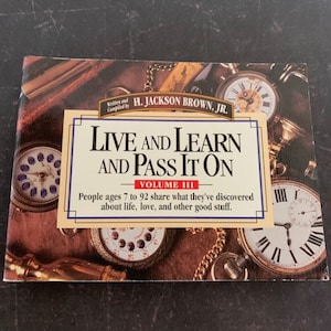 May include: A book titled "Live and Learn and Pass It On" Volume III. The book cover features a collection of antique pocket watches with roman numeral faces and gold chains. The book is written and compiled by H. Jackson Brown, Jr. and features stories from people ages 7 to 92.