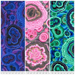 May include: Three fabric panels with abstract designs. The left panel features a blue and purple pattern, the centre panel has a pink and grey design, and the right panel displays a green and blue pattern. Each panel has a ruler along the bottom edge.