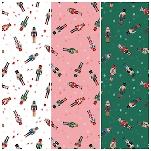 May include: Three panels of patterned fabric featuring a repeating design of toy nutcrackers and small Christmas trees. The backgrounds are white, pink, and green. The nutcrackers are in various colors, including red, green, blue, and gold.