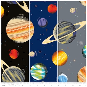 May include: Fabric panel featuring a colorful space-themed design. Planets like Jupiter, Saturn, and Mars are depicted with labels against a black, navy, and gray background. The panel is approximately 12 inches wide.