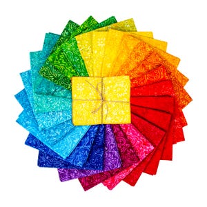May include: A colourful arrangement of fabric squares in a circular pattern, displaying a rainbow of hues. The fabric features a patterned design. A yellow bundle of fabric is tied with twine in the centre.