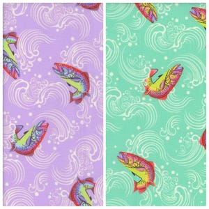 May include: Two fabric panels featuring a repeating pattern of colourful fish and white wave designs. One panel is lavender, the other is mint green. The fish have red, yellow, and purple scales. The waves are stylised and add a sense of movement.