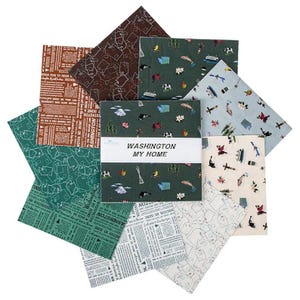 May include: A collection of fabric squares with various patterns and colors. Some squares feature newspaper-style text, while others display maps, orcas, and other Washington state-themed illustrations. The central square reads "WASHINGTON MY HOME."