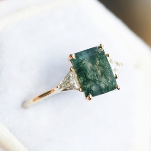 Emerald cut moss agate engagement ring, Three stone moss agate ring with side triangle diamonds