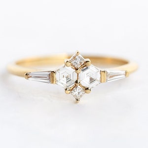 Ring with natural diamond in yellow gold. Diamond in the prong setting ring are styled as cluster ring. Shape of the diamonds are hexagonal, square and a tappered baguette.