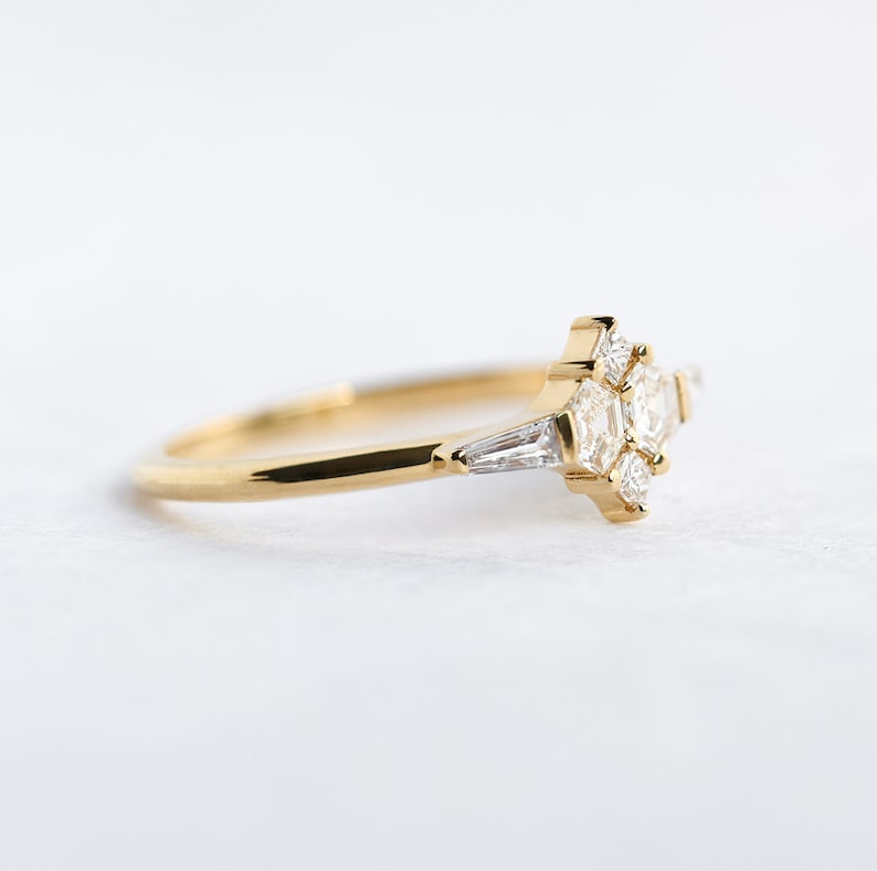 Ring with natural diamond in yellow gold. Diamond in the prong setting ring are styled as cluster ring. Shape of the diamonds are hexagonal, square and a tappered baguette.