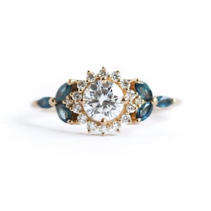 Halo moissanite diamond ring with side teal blue marquise sapphires