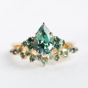 Mermaid sapphire engagement ring set with clustered sapphire band