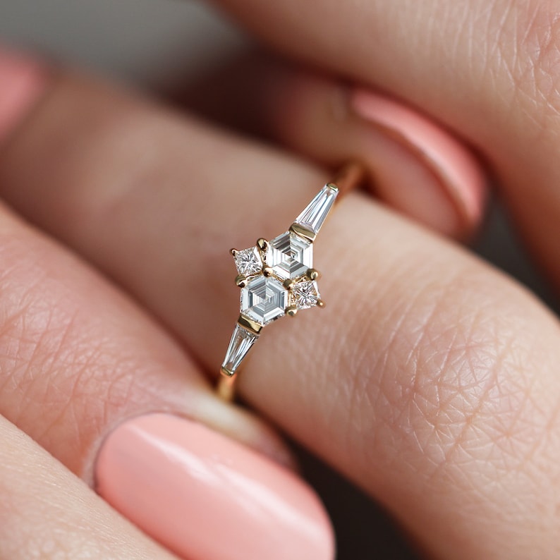 Ring with natural diamond in yellow gold. Diamond in the prong setting ring are styled as cluster ring. Shape of the diamonds are hexagonal, square and a tappered baguette.