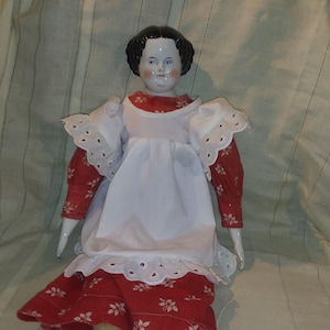 Antique porcelain head and hands low brow style doll. Black hair, soft body, red dress. 24 inches. High quality. Free Shipping!