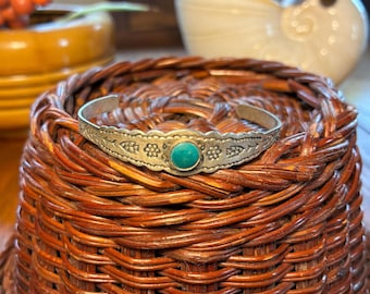 Pretty vintage Navajo style silver tone cuff bracelet with engraved markings and center turquoise stone. Free Shipping!