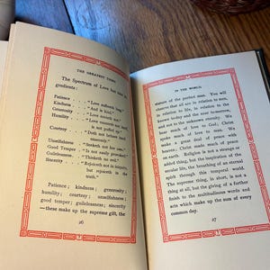 May include: An open book with text in black ink, framed by a red border. The left page lists "The Spectrum of Love" with its "ingredients." The right page continues the text, discussing "the perfect man" and the importance of love.