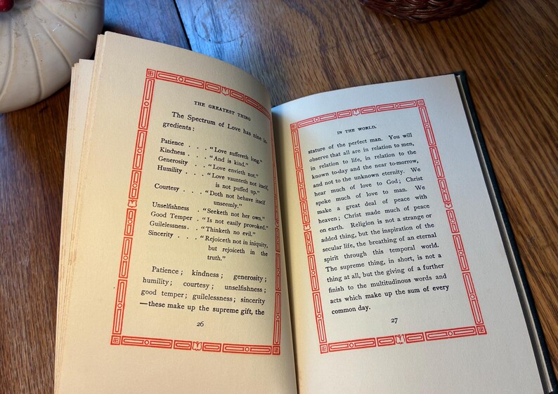 May include: An open book with text in black ink, framed by a red border. The left page lists "The Spectrum of Love" with its "ingredients." The right page continues the text, discussing "the perfect man" and the importance of love.