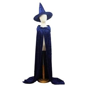 May include: A dark blue velvet witch costume, including a pointed hat and a long hooded cloak. The costume is displayed on a mannequin, showcasing the flowing fabric and design. The hat has a wide brim and a tall, pointed crown.