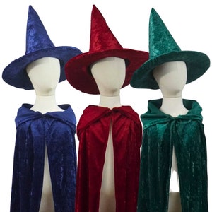 May include: Three velvet witch costumes with pointed hats. The hats are blue, red, and green. The capes are blue, red, and green.
