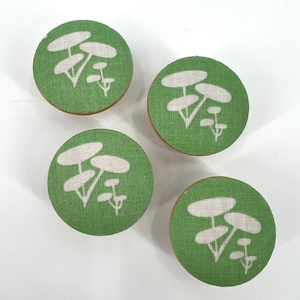May include: Four green fabric knobs with white stylized mushroom designs.