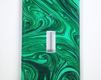 May include: Green and black marbled light switch cover with a white cutout for the switch.