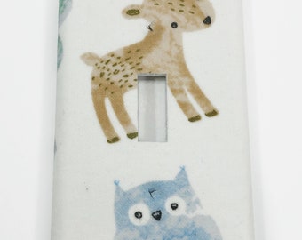 May include: A white light switch cover with a brown deer and a blue owl design. The deer has brown spots and the owl has a white belly.