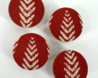 May include: Four round fabric covered knobs with a white geometric pattern on a red background.