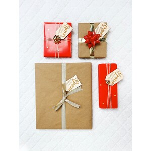 May include: Four wrapped gifts with red and brown paper. Each gift has a tag with the words "Something they need", "Something they want", "Something they read", and "Something they wear".