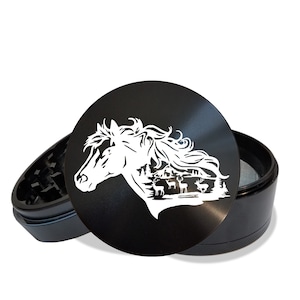 May include: Black metal grinder with a white silhouette of a horse's head and a forest scene with deer. The grinder is open and the top is off.