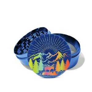 May include: A blue metal grinder with a colorful mountain scene design. The design features a rainbow gradient and a sunburst effect. The grinder is open, revealing the grinding mechanism.
