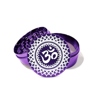 May include: Purple metal grinder with a white Om symbol and mandala design.