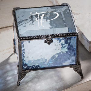 May include: A handmade wooden sign saying "Welcome to our home" in a handwritten style. The sign is painted white with black lettering and a distressed finish, suitable for indoor or outdoor use.