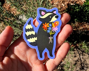 花を持ったアライグマのビニールステッカー
