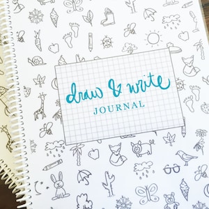 May include: A white spiral bound journal with a black and white patterned cover. The cover features various small drawings of animals, plants, and objects. The title "Draw & Write JOURNAL" is written in blue cursive on a white rectangle.