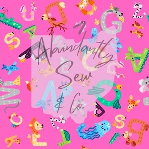 May include: Pink fabric with a repeating pattern of colorful letters and animals. The letters are in a variety of fonts and styles, and the animals are cartoonish and whimsical. The fabric is perfect for crafting projects, such as quilts, pillows, and tote bags.
