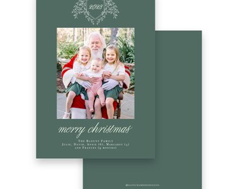 May include: A Christmas card with a photo of Santa Claus and three children. The card is dark green with the words "merry christmas" in cursive. The family's names and ages are listed below the text. A decorative crest with the year 2023 is at the top.