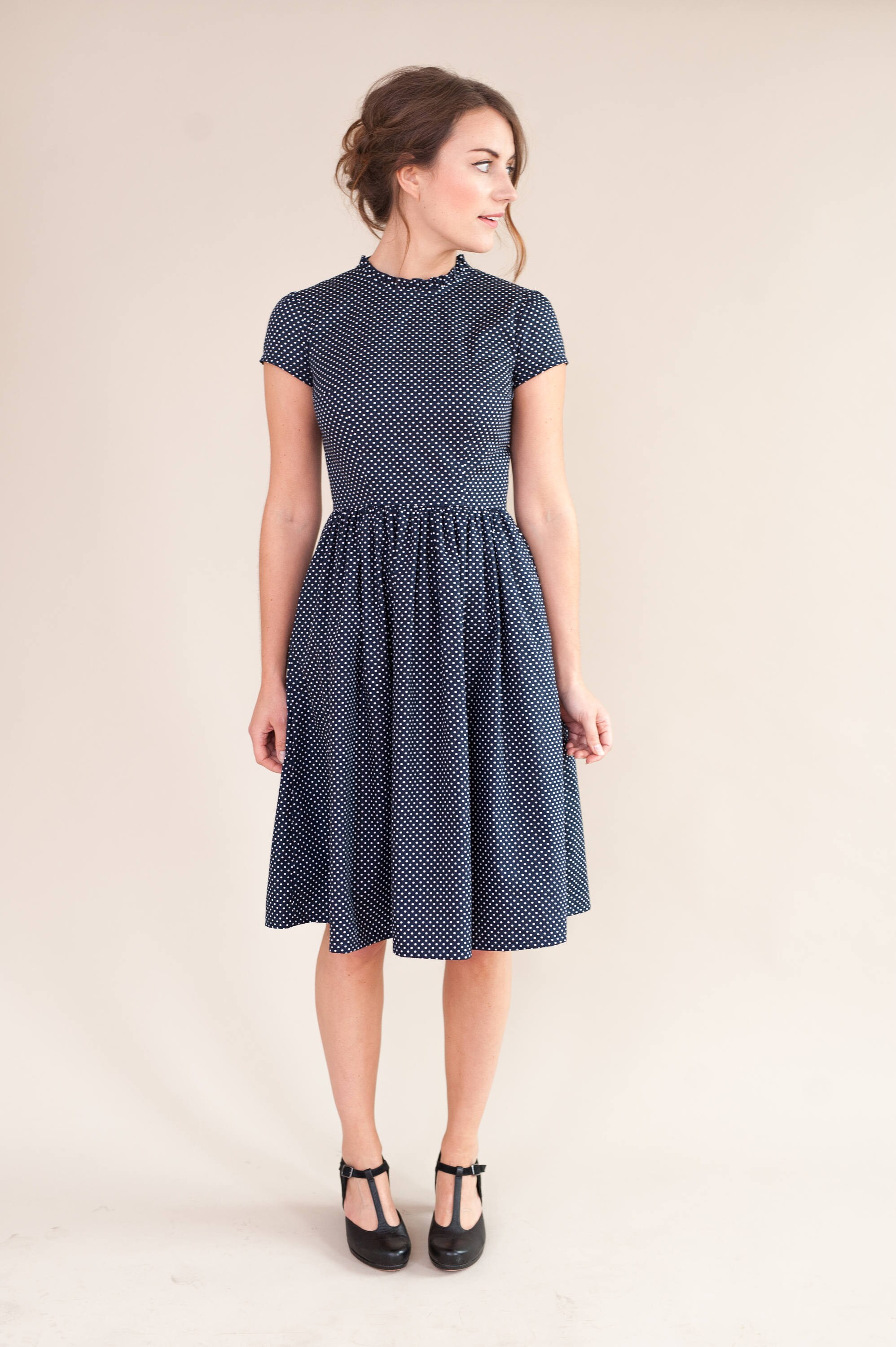 Navy spotty dress with ruffled neckline
