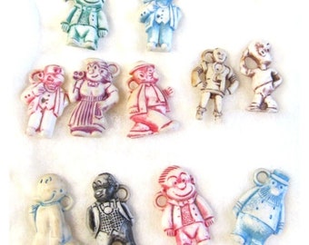 VINTAGE 11 pequenos prêmios de biscoito de jornal de plástico Jack amuletos de desenho animado dos anos 1930