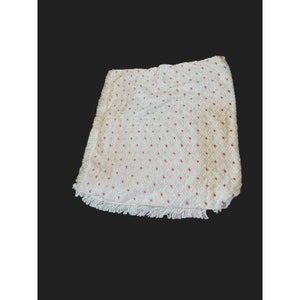 May include: White throw blanket with a red polka dot pattern and a fringe border.