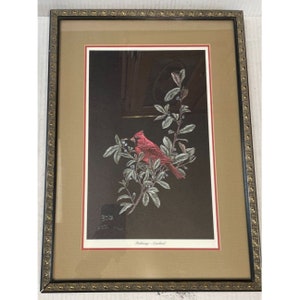 Könnte beinhalten: Gerahmter Druck eines roten Kardinals, der auf einem Zweig mit grünen Blättern und blauen Beeren sitzt. Der Druck ist signiert mit "Shirley  Dodge" und trägt den Titel "Flocksong - Cardinal".
