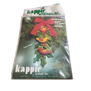 May include: A white ceramic mug with a black handle and the text "But First, Coffee" in a black, handwritten-style font. The mug is on a white surface.