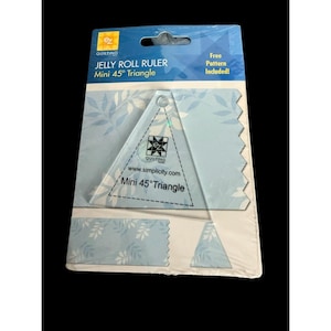 May include: A clear acrylic quilting ruler shaped as a mini 45-degree triangle, packaged on a blue card with white leaf patterns. The ruler features the text EZ Quilting, simplicity.com, and Mini 45 Degree Triangle printed in black on its surface.