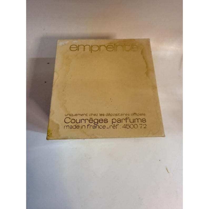 May include: A vintage perfume box with the word "empreinte" in a stylized font. The box is a light tan color with text that reads "Courr&egrave;ges parfums made in france". The box has a reference number 450072.