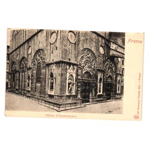 May include: Vintage postcard featuring a black and white image of the Chiesa d'Orsanmichele in Florence, Italy. The postcard shows the exterior of the church with detailed architectural elements, including statues and arched windows. The word "Firenze" is printed on the top right.