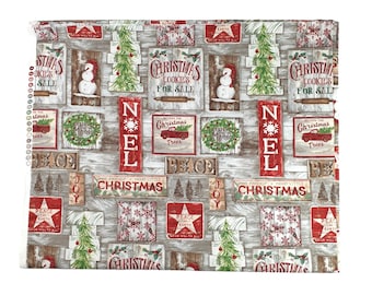 May include: A white and brown fabric with a Christmas theme. The fabric features a repeating pattern of wooden signs with Christmas-themed text, including "Christmas Cookies for Sale", "Believe in Magic", "Peace on Earth", and "Joy". The signs are decorated with red and green accents, including snowflakes, stars, and pine trees.