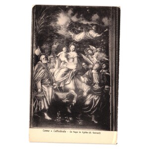 May include: Vintage black and white postcard featuring a religious painting depicting a biblical scene. The artwork shows figures on a donkey, angels, and other people. The postcard has text at the bottom, and is set against a white background.