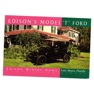 May include: A postcard featuring a black Model T Ford parked on a grassy lawn in front of a white house with a red roof. The text at the top reads "EDISON'S MODEL 'T' FORD". The bottom text reads "Edison Winter Home, Fort Myers, Florida".