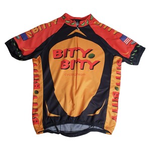 May include: A short-sleeved cycling jersey in orange, black, and red, featuring the text "BITY BITY cycling team." The jersey has a zipper and a design with lime green accents and small flags.