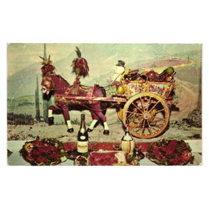 May include: Vintage postcard featuring a decorative horse-drawn cart laden with fruits and vegetables. The cart is pulled by a maroon horse with ornate decorations. Bottles of wine and food are displayed on a table in front of a painted backdrop.