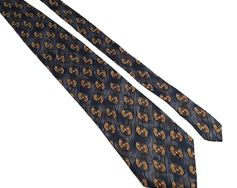 May include: A navy blue tie with a repeating pattern of brown and gold oval shapes. The tie has a subtle, textured appearance and is angled across a white background.