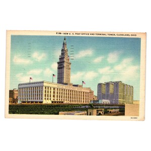 May include: Vintage postcard featuring the New U.S. Post Office and Terminal Tower in Cleveland, Ohio. The image shows a tall, ornate tower and a large building with American flags. The sky is blue with light clouds.