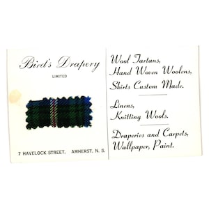 May include: A vintage business card for Bird's Drapery, featuring a fabric swatch with green, blue, and red stripes. The card lists services like wool tartans, hand-woven woolens, and custom-made skirts. The address is 7 Havelock Street, Amherst, N.S.