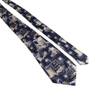 May include: Navy blue tie featuring a repeating pattern of retro computers, the words "e-mail" and "Internet". The tie has a diagonal design with a light beige background and blue accents.