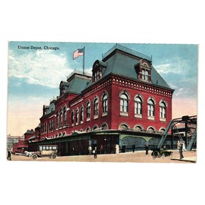 May include: A vintage postcard showing Union Depot in Chicago. The building is a large red brick structure with arched windows and a dark roof. An American flag flies above. The text "Union Depot, Chicago" is printed at the top of the postcard.